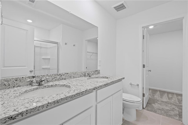 3064 Orwell Dr, Gainesville, GA 30507 - bathroom featuring toilet, double vanity, a stall shower, tile patterned flooring, and a walk in closet