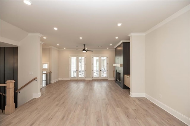 unfurnished living room with french doors, elevator, ornamental molding, and light hardwood / wood-style flooring