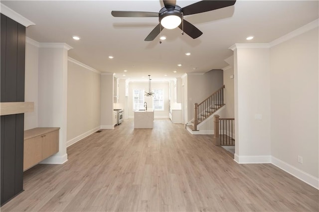 living room with sink, light hardwood / wood-style flooring, ornamental molding, and ceiling fan