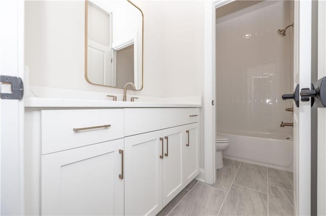 full bathroom with shower / tub combination, vanity, and toilet