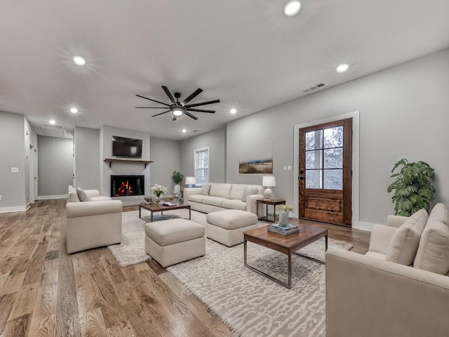 unfurnished living room featuring light hardwood / wood-style floors and ceiling fan