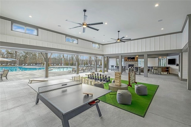 interior space featuring a community pool and a ceiling fan