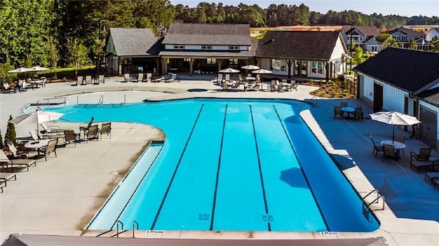 pool featuring a residential view and a patio