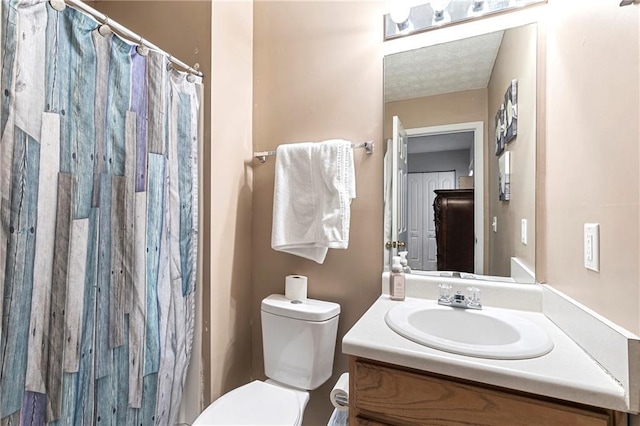 bathroom featuring vanity, toilet, and a shower with curtain