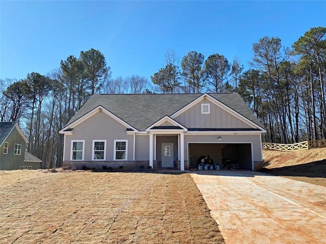 craftsman-style home with board and batten siding, driveway, and a garage