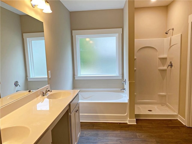 full bath featuring wood finished floors, a sink, and a shower