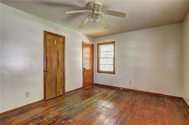 unfurnished room featuring baseboards, a ceiling fan, and hardwood / wood-style flooring
