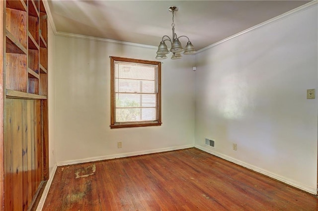 empty room with hardwood / wood-style flooring, baseboards, visible vents, crown molding, and a notable chandelier