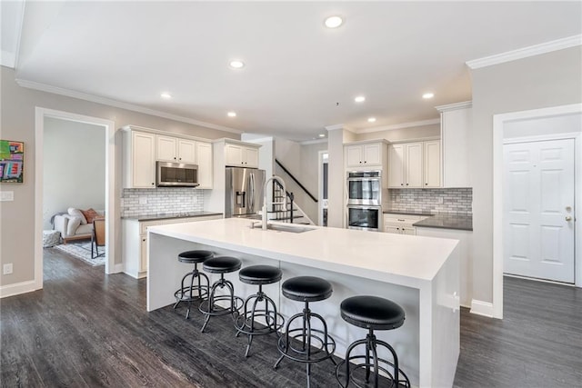 5041 Corinault Pl NW, Acworth, GA 30101 - kitchen with stainless steel appliances, a sink, dark wood-style flooring, ornamental molding, and backsplash