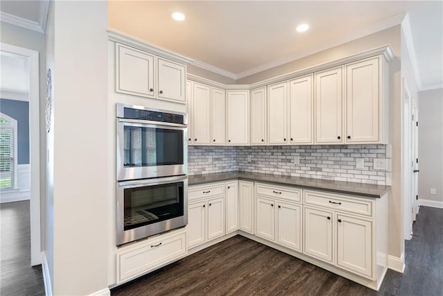 5041 Corinault Pl NW, Acworth, GA 30101 - kitchen with stainless steel double oven, dark wood-type flooring, crown molding, dark countertops, and recessed lighting