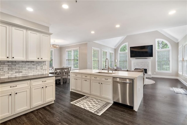 5041 Corinault Pl NW, Acworth, GA 30101 - kitchen with stainless steel dishwasher, a sink, dark wood-type flooring, a fireplace, and a center island with sink