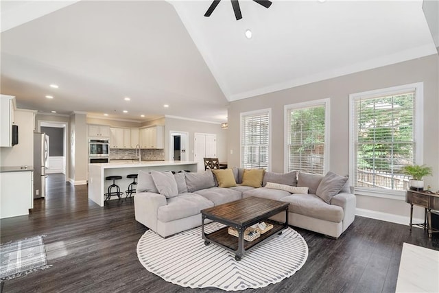 5041 Corinault Pl NW, Acworth, GA 30101 - living room featuring lofted ceiling, crown molding, a ceiling fan, dark wood-type flooring, and baseboards