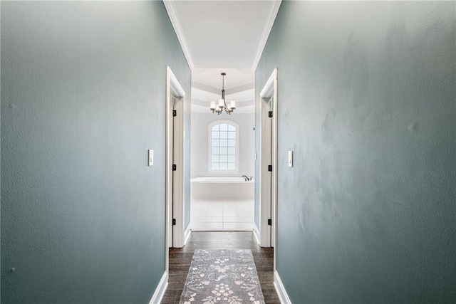 5041 Corinault Pl NW, Acworth, GA 30101 - hall with dark wood-style flooring, a chandelier, baseboards, and crown molding