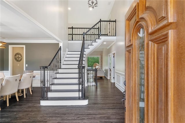 5041 Corinault Pl NW, Acworth, GA 30101 - foyer with a high ceiling, stairway, ornamental molding, dark wood-style flooring, and a wainscoted wall
