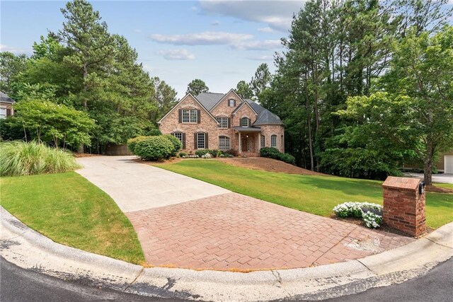 5041 Corinault Pl NW, Acworth, GA 30101 - french country inspired facade with concrete driveway, a front yard, brick siding, and stone siding