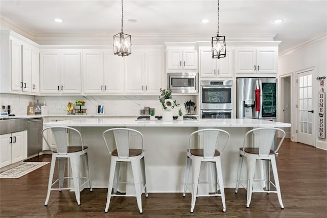 882 Hallbrook Ln, Milton, GA 30004 - kitchen featuring stainless steel appliances, white cabinetry, light countertops, ornamental molding, and recessed lighting