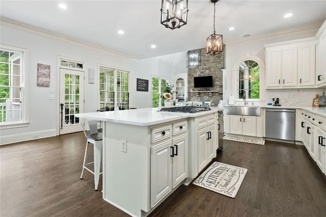 882 Hallbrook Ln, Milton, GA 30004 - kitchen featuring appliances with stainless steel finishes, a sink, crown molding, dark wood-style flooring, and white cabinetry