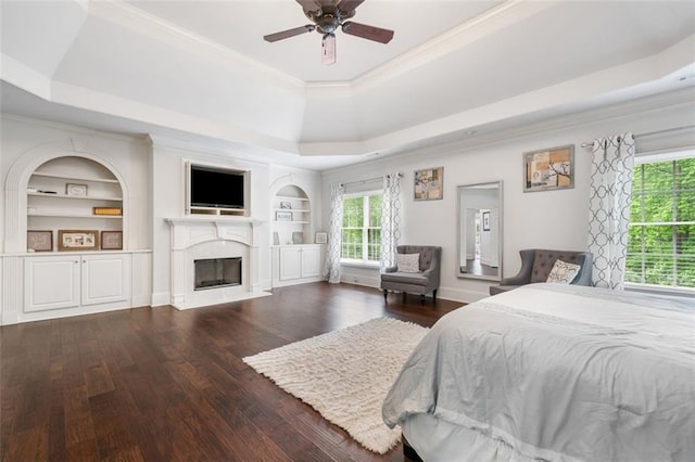 882 Hallbrook Ln, Milton, GA 30004 - bedroom with a tray ceiling, hardwood / wood-style flooring, crown molding, a fireplace, and ceiling fan