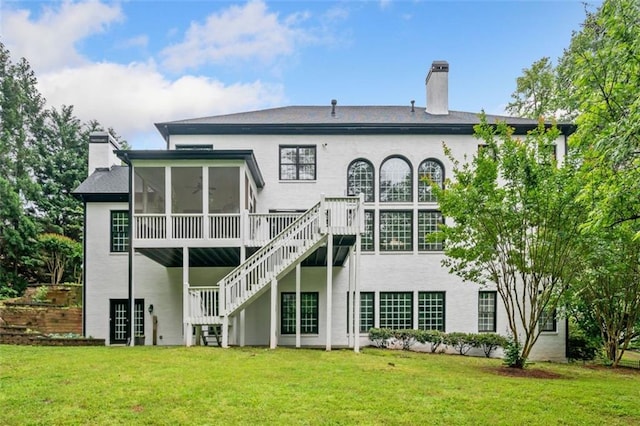 882 Hallbrook Ln, Milton, GA 30004 - back of house featuring stairs, a chimney, a sunroom, and a lawn