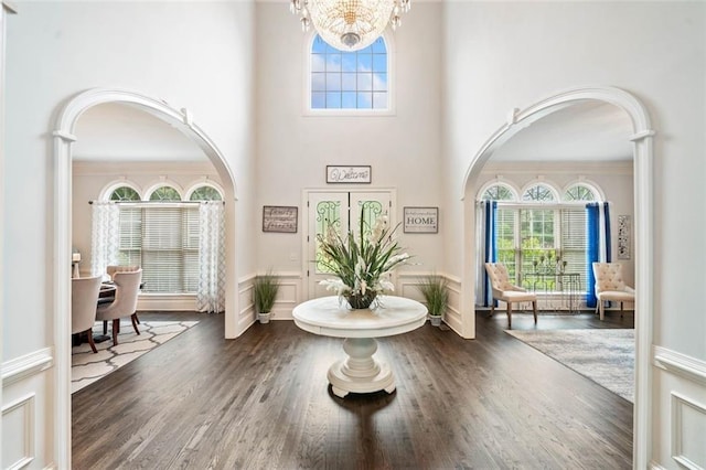 882 Hallbrook Ln, Milton, GA 30004 - foyer featuring arched walkways, healthy amount of natural light, a chandelier, wood finished floors, and a towering ceiling