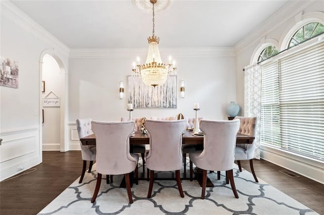 882 Hallbrook Ln, Milton, GA 30004 - dining room with a chandelier, crown molding, wood finished floors, and arched walkways