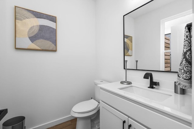 bathroom with vanity, wood-type flooring, and toilet