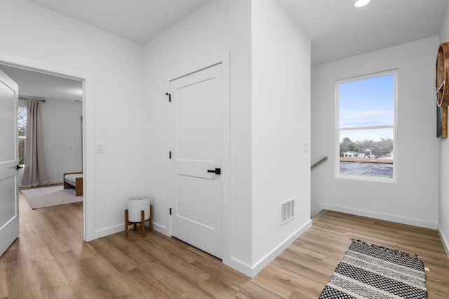 hallway with light hardwood / wood-style flooring