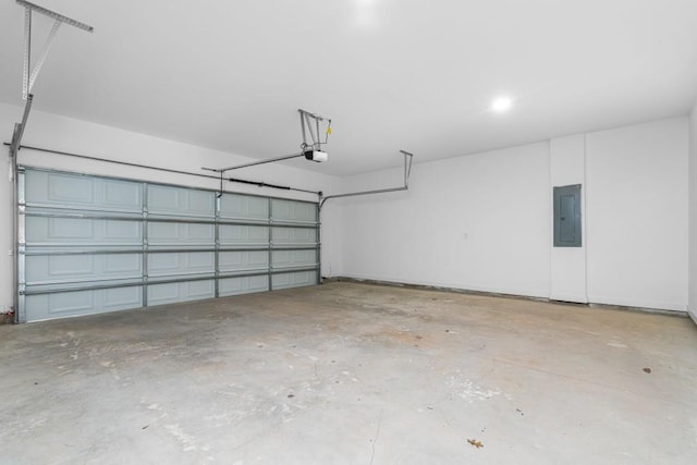 garage with a garage door opener and electric panel