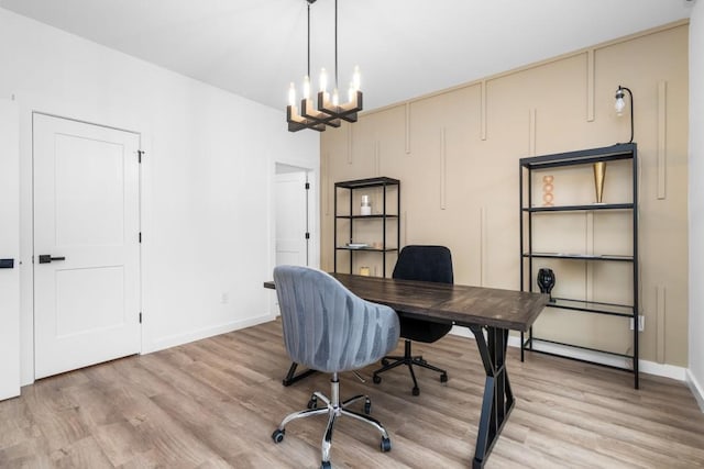 office featuring a notable chandelier and light hardwood / wood-style flooring