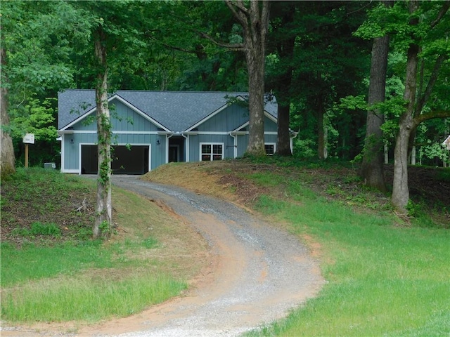 100 Elbert Gaddis Rd, Dahlonega, GA 30533 - view of front facade with dirt driveway, a garage, and a shingled roof