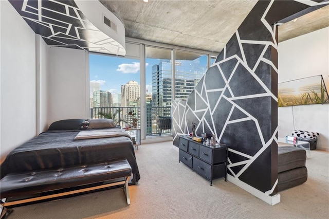 bedroom featuring a wall of windows, multiple windows, and carpet