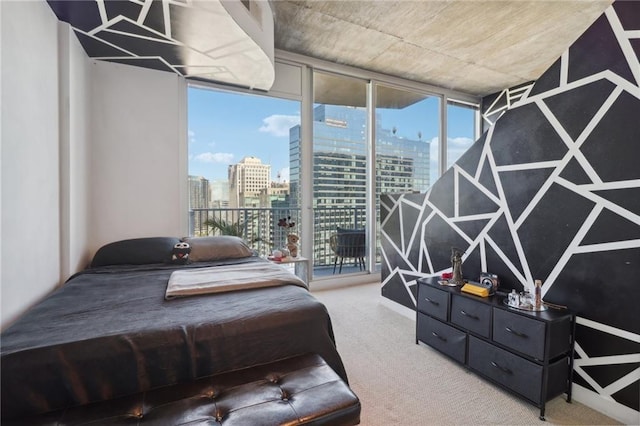 bedroom with multiple windows, access to outside, a wall of windows, and carpet