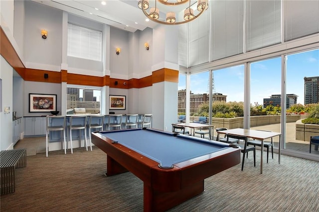 game room with pool table, carpet floors, and a high ceiling