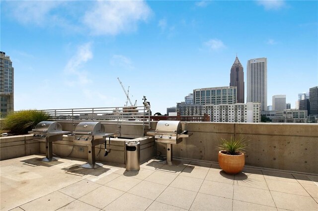 view of patio featuring area for grilling and a grill