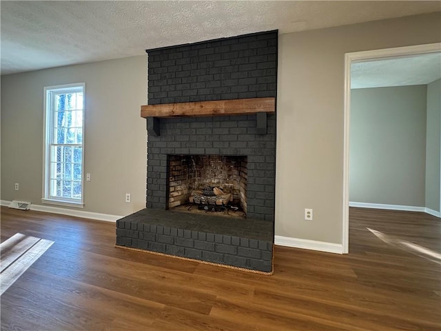 interior details with hardwood / wood-style floors, a fireplace, and a textured ceiling