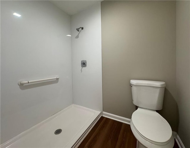 bathroom featuring walk in shower, toilet, and hardwood / wood-style floors