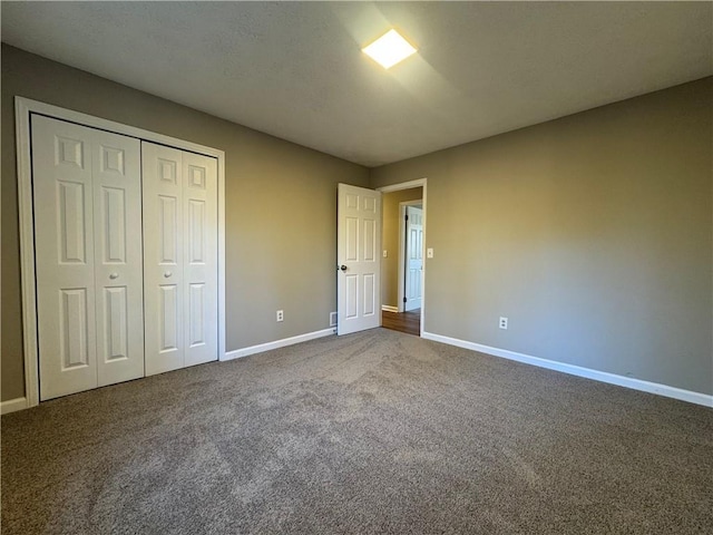 unfurnished bedroom featuring carpet flooring and a closet