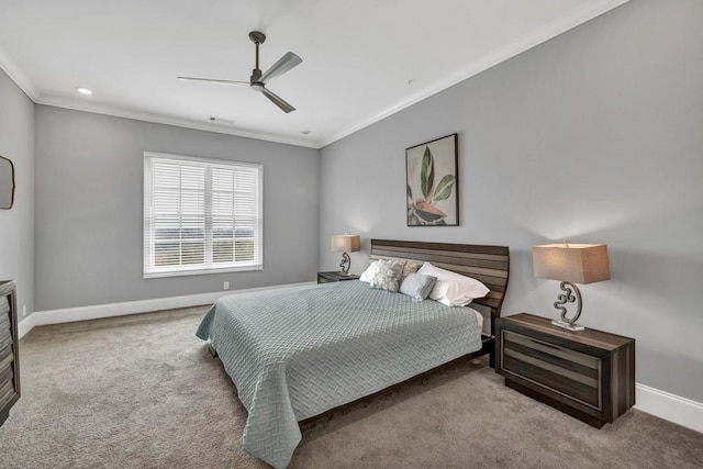 carpeted bedroom with baseboards, crown molding, and ceiling fan