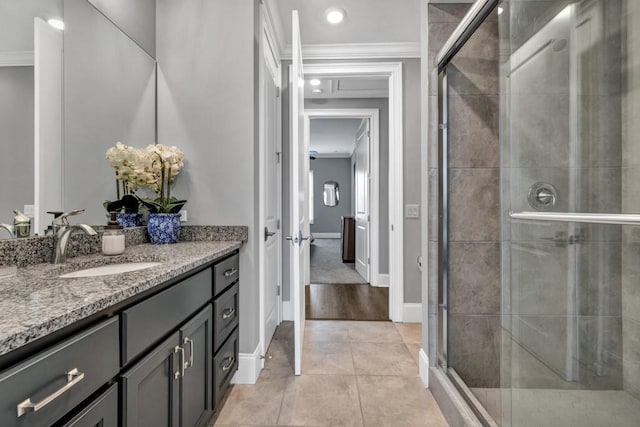 full bath featuring a stall shower, tile patterned floors, and crown molding