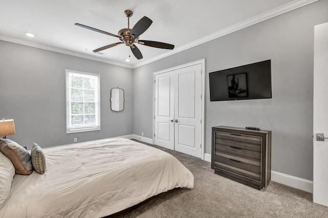 bedroom featuring carpet flooring, baseboards, a closet, and ornamental molding