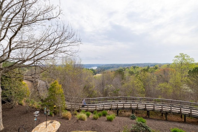 view of yard featuring fence and a forest view