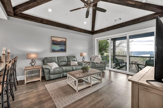 living area with a ceiling fan, visible vents, beamed ceiling, and dark wood finished floors