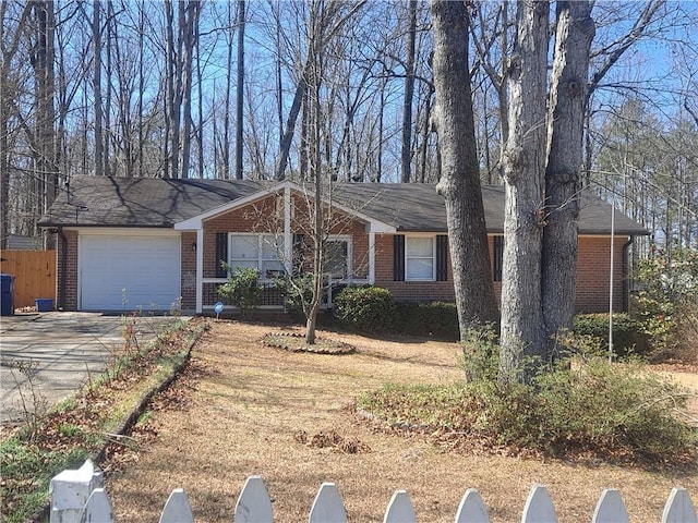 359 Cedar Ridge Trl, Lawrenceville, GA 30046 - ranch-style home with brick siding, fence, a garage, and concrete driveway