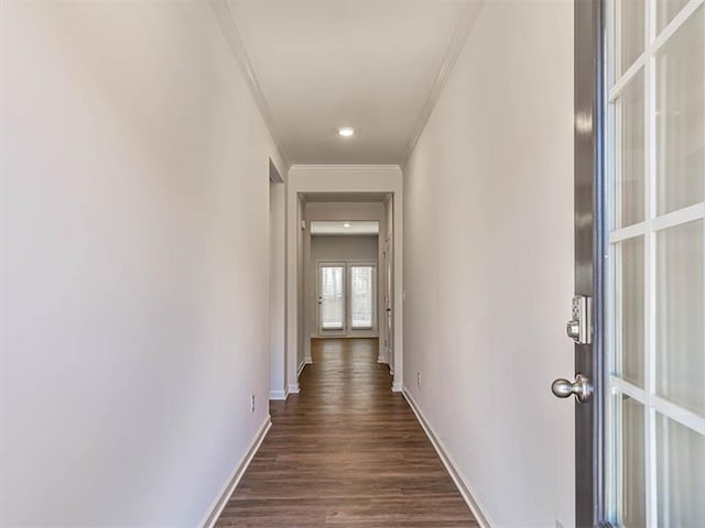 hallway featuring dark hardwood / wood-style floors and crown molding