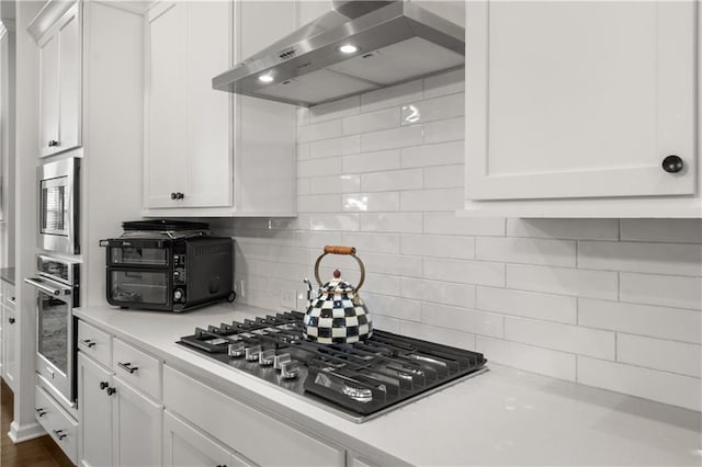 3 Hundley Ln, Roswell, GA 30076 - kitchen featuring appliances with stainless steel finishes, wall chimney exhaust hood, light countertops, and white cabinets
