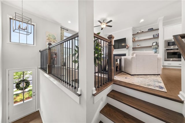 3 Hundley Ln, Roswell, GA 30076 - stairs featuring crown molding, a chandelier, ceiling fan, recessed lighting, and wood finished floors
