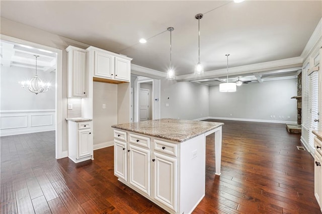 kitchen with dark wood-type flooring, beamed ceiling, open floor plan, and coffered ceiling