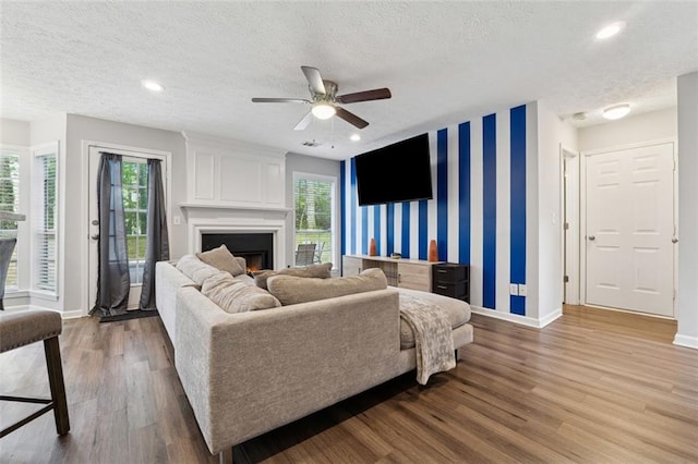 4147 Pinehurst Valley Dr, Decatur, GA 30034 - living room featuring baseboards, wallpapered walls, a textured ceiling, healthy amount of natural light, and wood finished floors