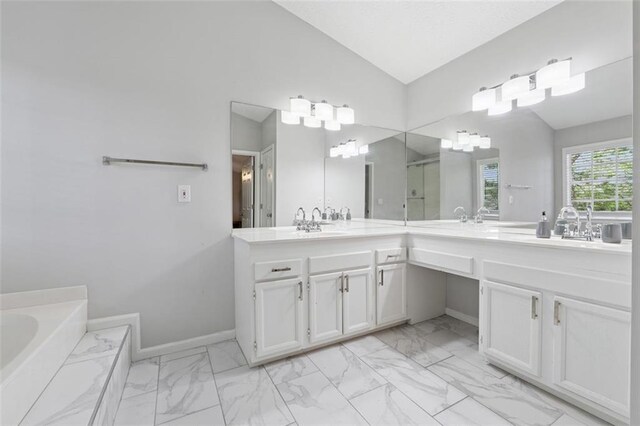 4147 Pinehurst Valley Dr, Decatur, GA 30034 - bathroom featuring marble finish floors, double vanity, vaulted ceiling, a garden tub, and a shower stall
