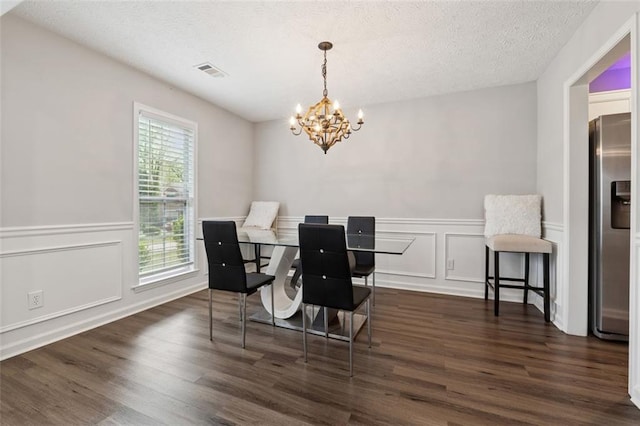 4147 Pinehurst Valley Dr, Decatur, GA 30034 - dining room featuring a chandelier, a decorative wall, dark wood-style floors, wainscoting, and a textured ceiling